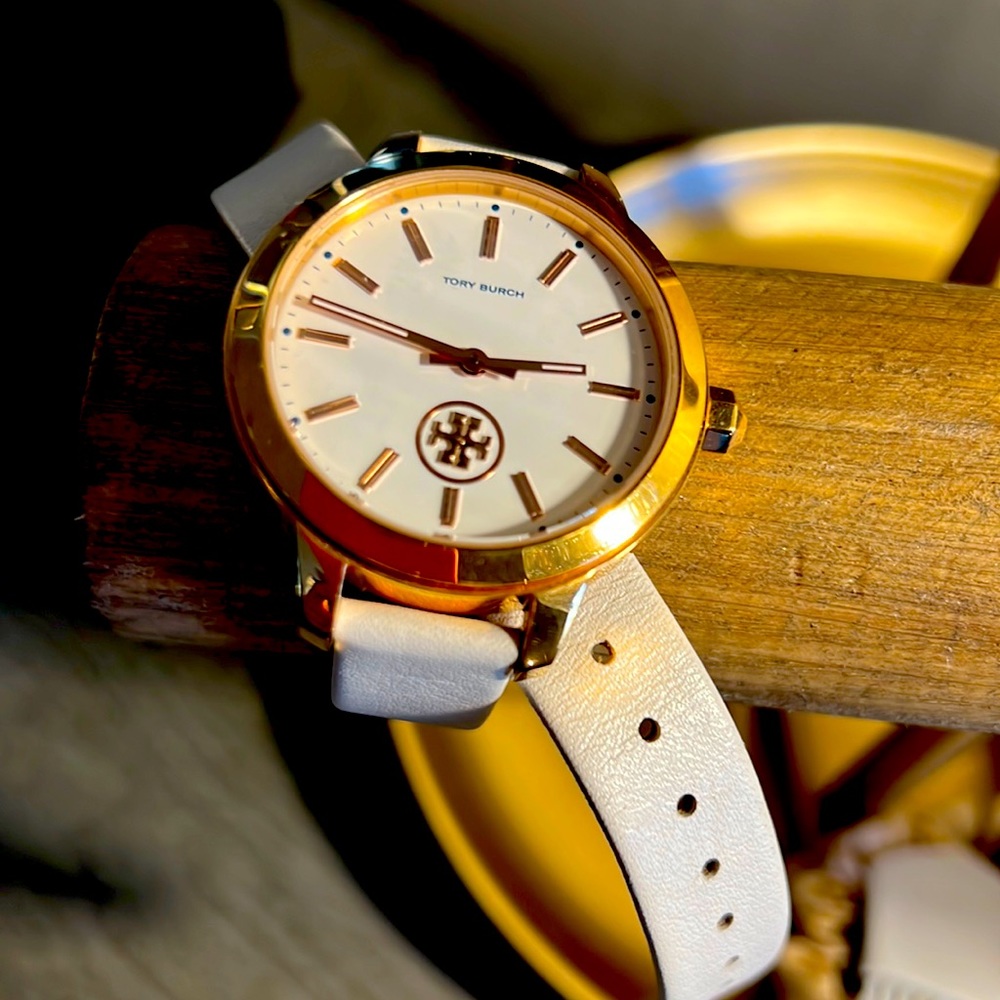 Tory Burch leather strap watch.